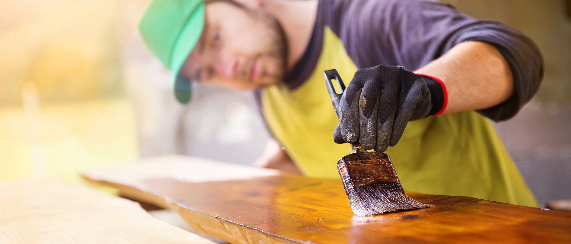 Handyman Varnishing Wooden Plank